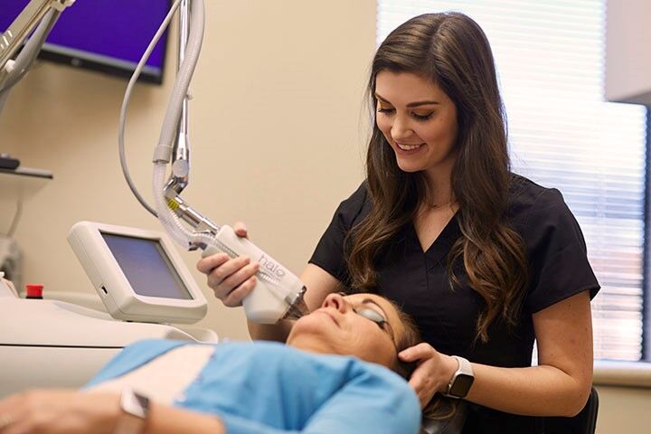 SLUCare esthetician, Paige Campbell, performing HALO treatment on a patient